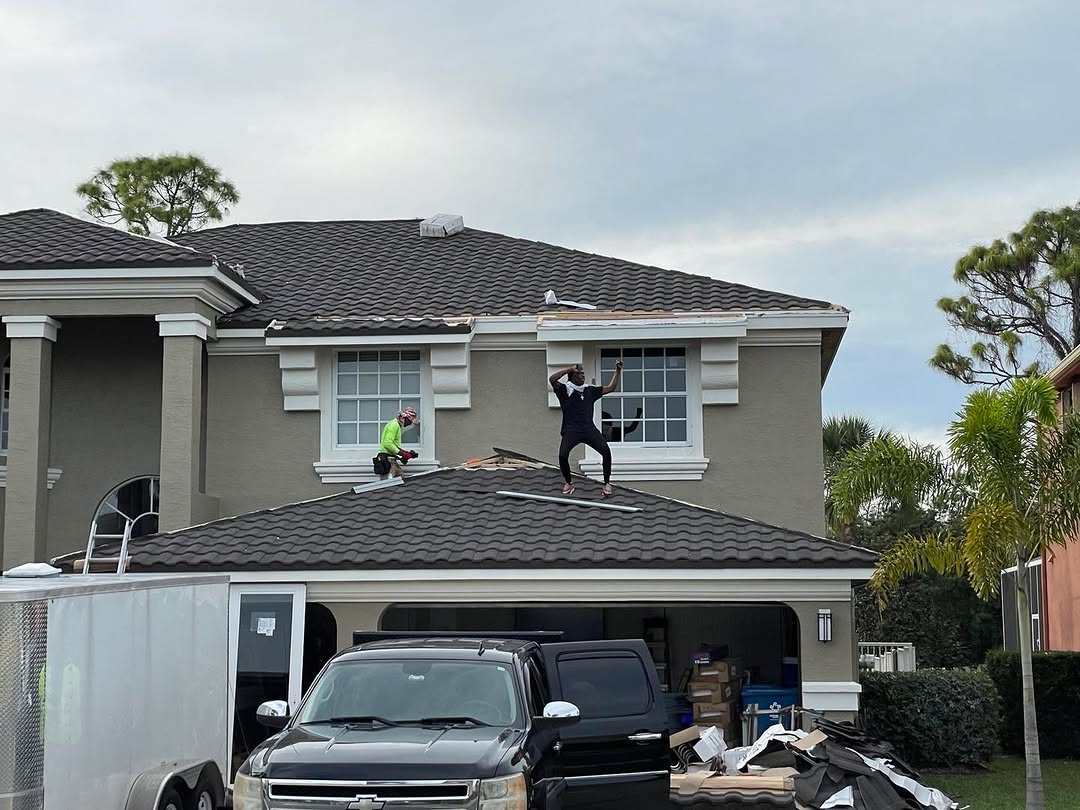 Crew installing metal shingle roofing